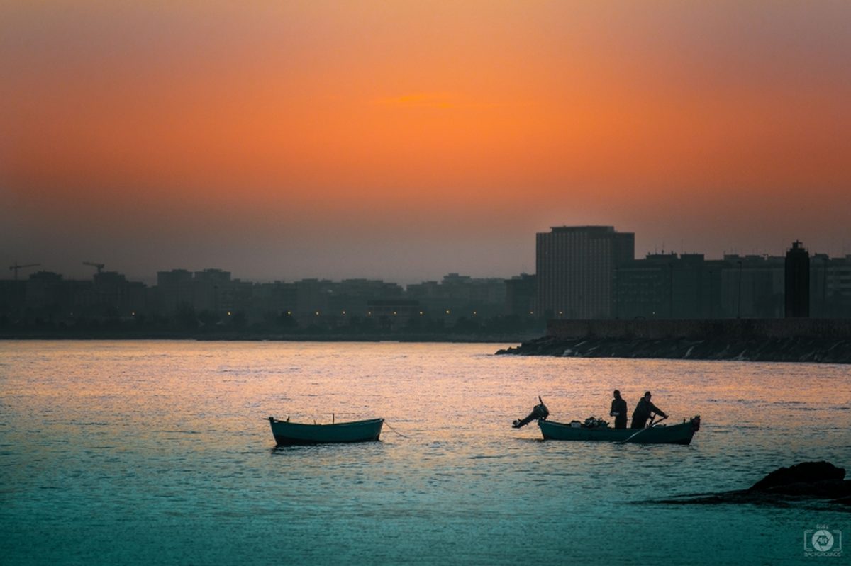 Fishing boats on calm water at dusk